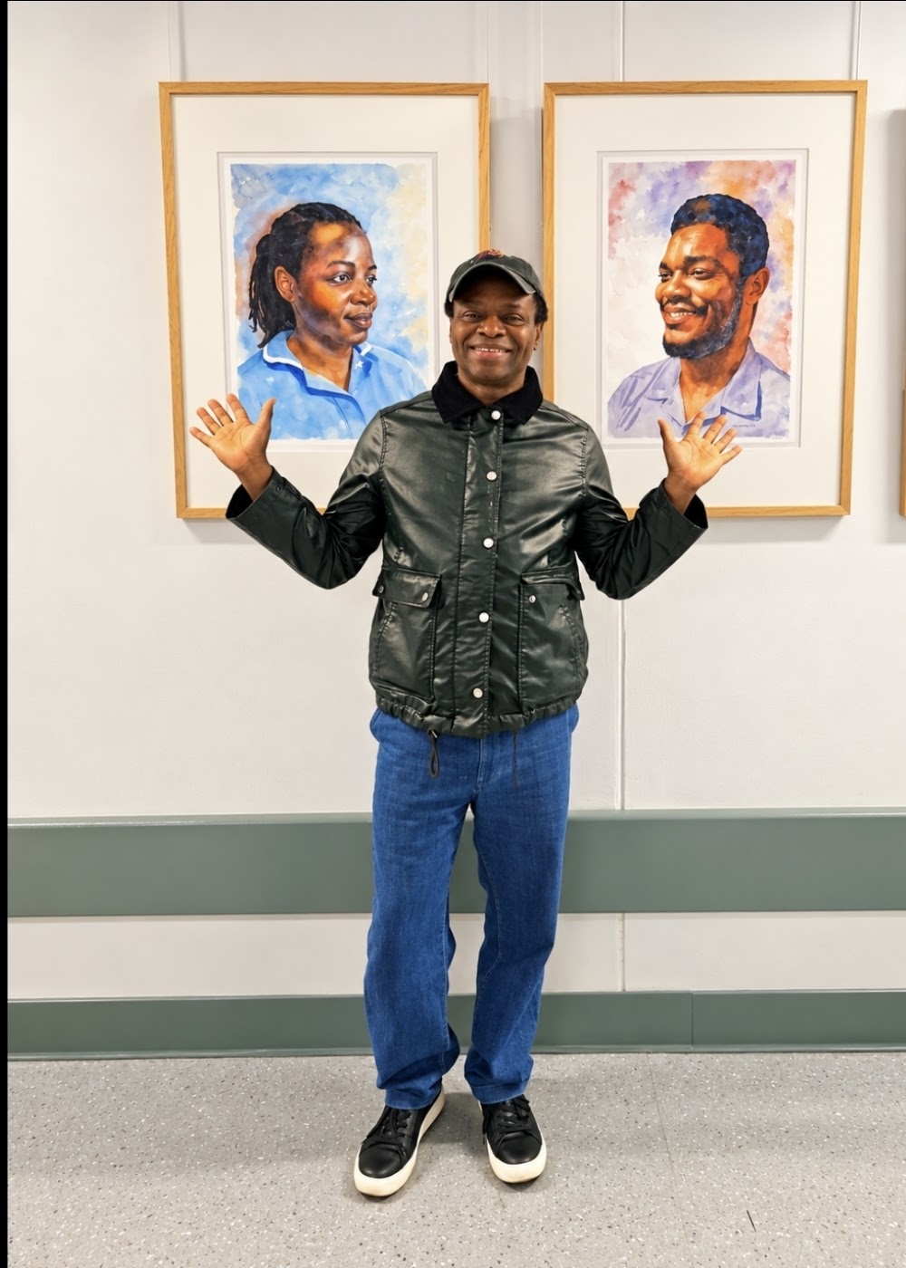Nduka Omeife beside his Black History Month portraits displayed at York Hospital