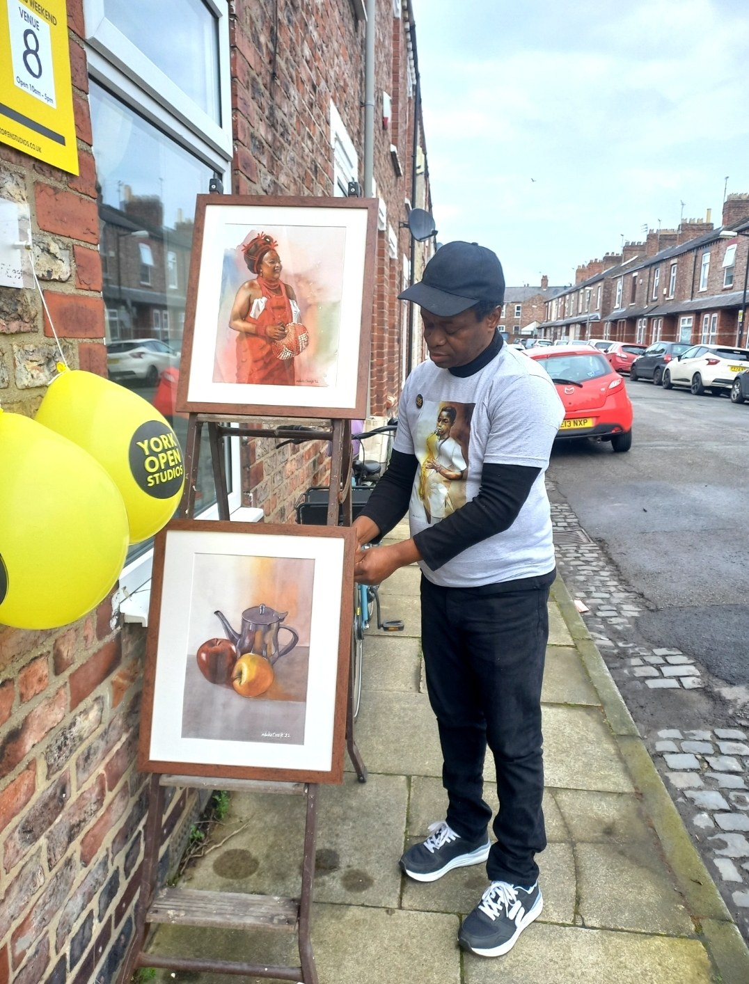 Nduka Omeife with paintings outside his York studio