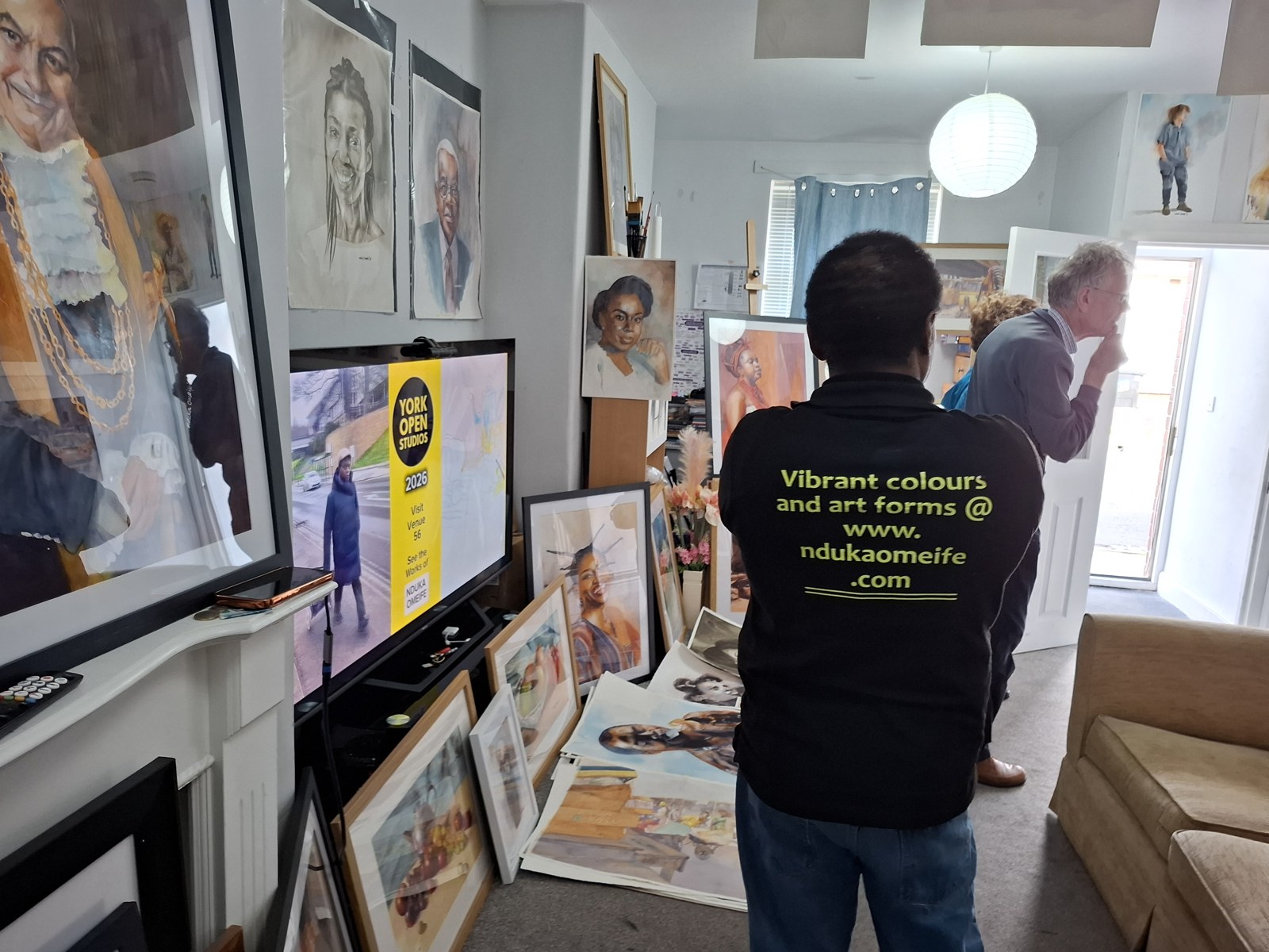Visitors viewing artwork inside the studio
