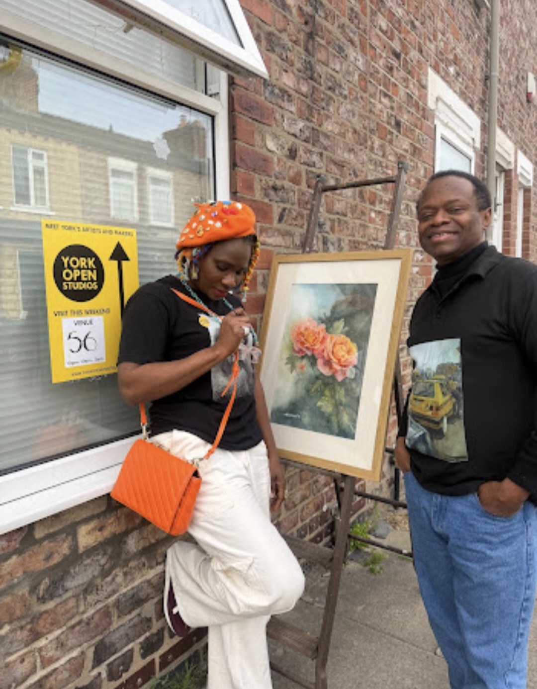 Nduka Omeife and a visitor beside a painting